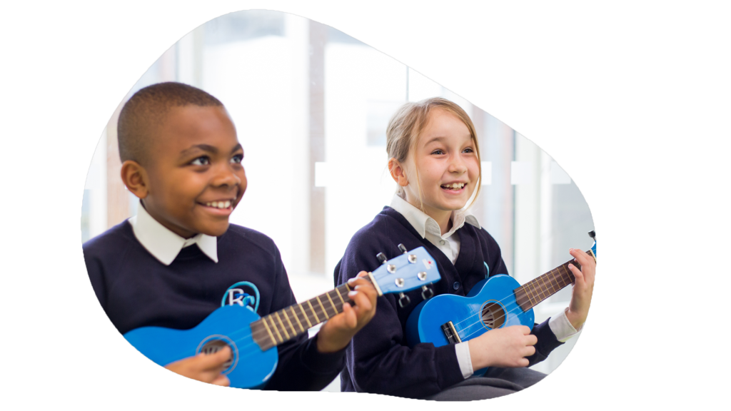 Two joyful schoolchildren are playing blue ukuleles, sharing a moment of musical learning and enjoyment. The boy looks to the side with a bright smile, while the girl, also smiling, focuses on strumming her instrument. They are both dressed in school uniforms, suggesting an engaging music lesson within an educational setting. The image is framed in a unique cloud-like shape, emphasizing the light-hearted and creative atmosphere.