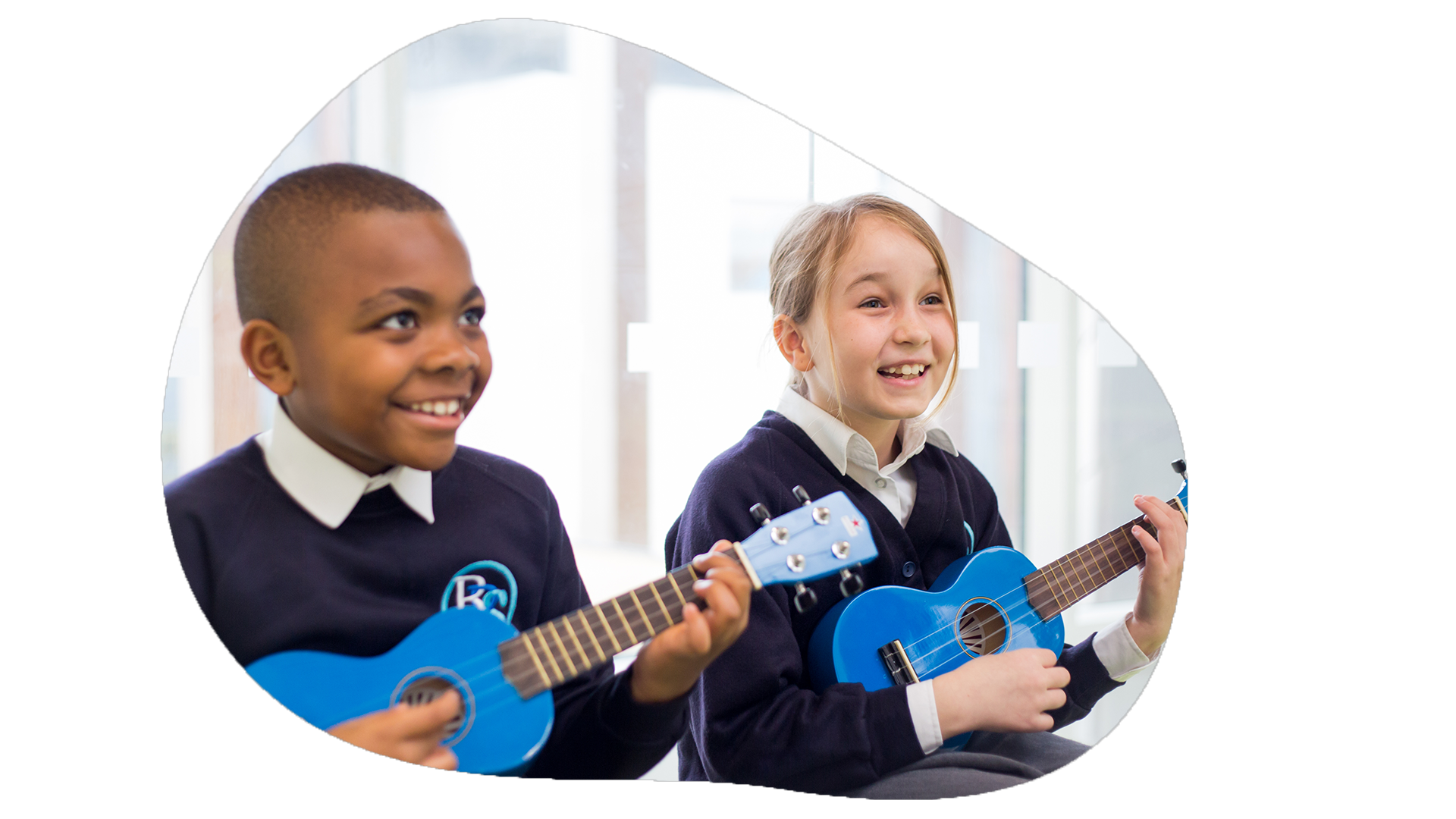 Two joyful schoolchildren are playing blue ukuleles, sharing a moment of musical learning and enjoyment. Their bright smiles and focused expressions convey a sense of fun and engagement with the activity, highlighting the interactive and creative aspects of music education. The setting appears to be a bright classroom, enhancing the lively and positive atmosphere of the scene.